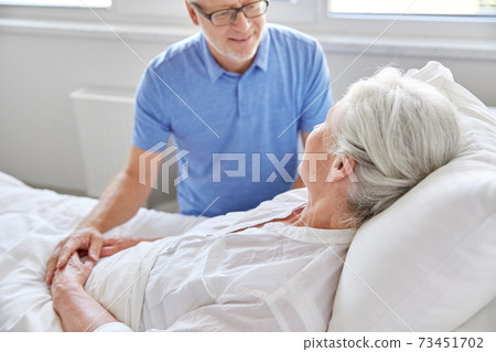 senior couple meeting at hospital ward 73451702