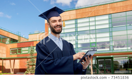 male graduate student or bachelor with tablet pc male graduate student or bachelor with tablet pc 73451836