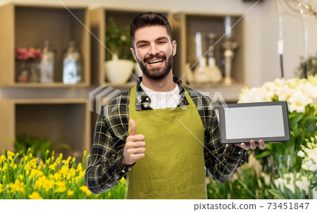 flower seller with tablet pc shows thumbs up 73451847