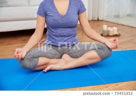 close up of woman meditating in lotus pose at home close up of woman meditating in lotus pose at home 73451852
