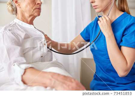 doctor with stethoscope and old woman at hospital doctor with stethoscope and old woman at hospital 73451853