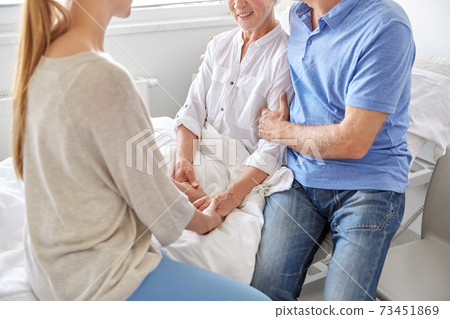 happy family visiting senior woman at hospital happy family visiting senior woman at hospital 73451869