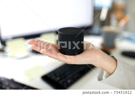 businesswoman using smart speaker at office 73451912