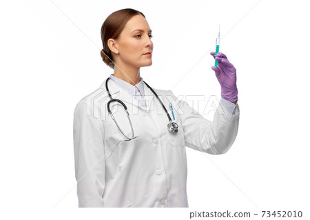 female doctor with medicine in syringe female doctor with medicine in syringe 73452010