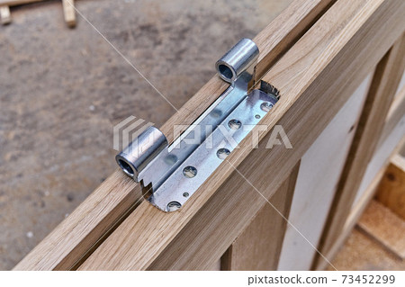 Joinery. Door leaf. Door hinge installation. Wood door manufacturing process. Furniture manufacture Joinery. Door leaf. Door hinge installation. Wood door manufacturing process. Furniture manufacture 73452299