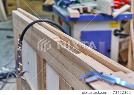 Joinery. Door leaf. Door lock installation. Wood door manufacturing process. Furniture manufacture 73452303