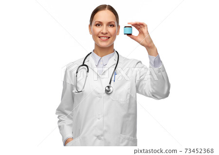 smiling female doctor holding jar of medicine smiling female doctor holding jar of medicine 73452368