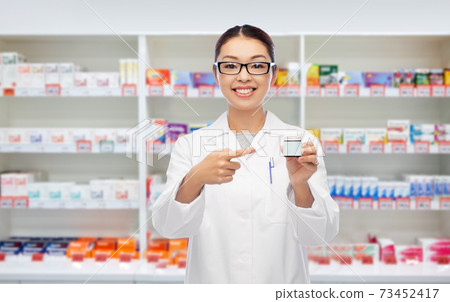 asian female pharmacist or doctor with medicine asian female pharmacist or doctor with medicine 73452417