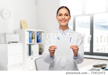 smiling female doctor with prescription blank 73452473