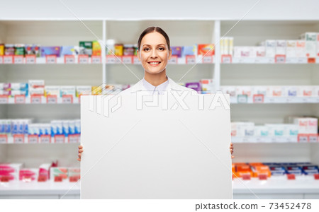happy smiling female pharmacist with white board happy smiling female pharmacist with white board 73452478