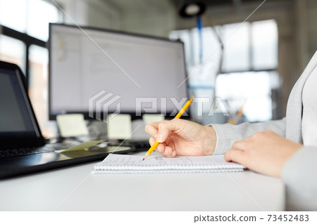 businesswoman with notebook and laptop at office businesswoman with notebook and laptop at office 73452483