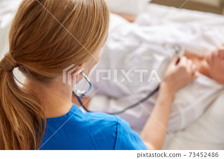 doctor with stethoscope and old woman at hospital doctor with stethoscope and old woman at hospital 73452486