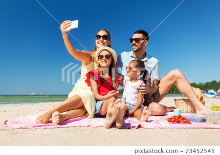happy family taking selfie on summer beach happy family taking selfie on summer beach 73452545