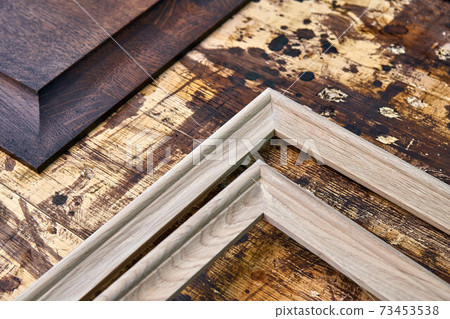 Joinery. Wood panels and moldings for entrance door. Wood door manufacturing process. Furniture manufacture Joinery. Wood panels and moldings for entrance door. Wood door manufacturing process. Furniture manufacture 73453538