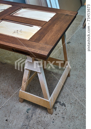 Joinery. Wood door manufacturing process. Door leaf, painted in dark color. Furniture manufacture Joinery. Wood door manufacturing process. Door leaf, painted in dark color. Furniture manufacture 73453673