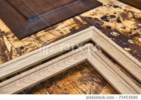 Joinery. Wood panels and moldings for entrance door. Wood door manufacturing process. Furniture manufacture Joinery. Wood panels and moldings for entrance door. Wood door manufacturing process. Furniture manufacture 73453680