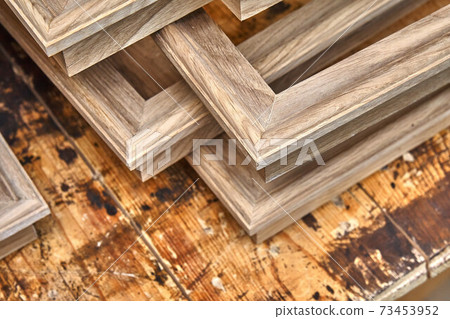 Joinery. Wooden moldings for entrance door. Wood door manufacturing process. Furniture manufacture Joinery. Wooden moldings for entrance door. Wood door manufacturing process. Furniture manufacture 73453952