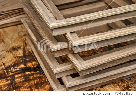 Joinery. Wooden moldings for entrance door. Wood door manufacturing process. Furniture manufacture 73453956