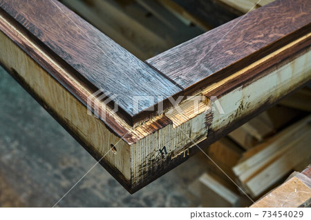 Joinery. Door frame, painted in dark color. Wood door manufacturing process. Furniture manufacture 73454029