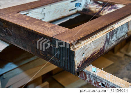 Joinery. Door frame, painted in dark color. Wood door manufacturing process. Furniture manufacture 73454034