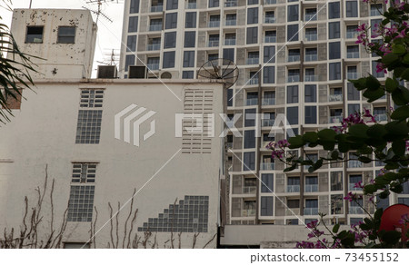 Architectural View of Overlapping old house buildings and modern condominium in bangkok, Thailand. 73455152