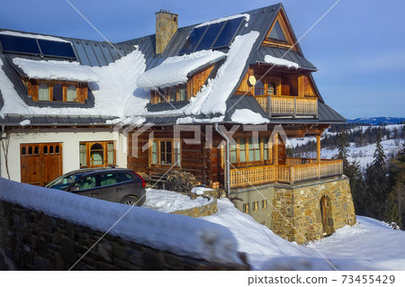 Wooden chalet in winter in Zakopane - Tatra Mountains Wooden chalet in winter in Zakopane - Tatra Mountains 73455429