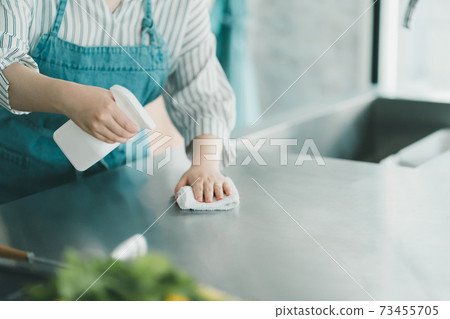 Housewife disinfecting the kitchen Housewife disinfecting the kitchen 73455705