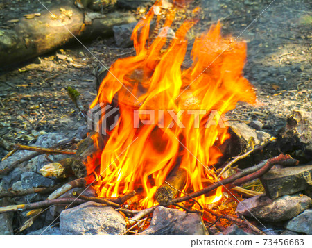 Smoked tourist kettle over camp fire in the evening 73456683