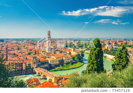 Aerial view of Verona historical city centre, Ponte Pietra bridge across Adige river, Verona Cathedral, Duomo di Verona, red tiled roofs 73457128