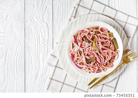 German sausage salad on a white plate, copy space German sausage salad on a white plate, copy space 73458351