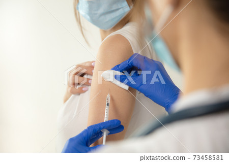 Close up doctor or nurse giving vaccine to patient using the syringe injected in hospital Close up doctor or nurse giving vaccine to patient using the syringe injected in hospital 73458581