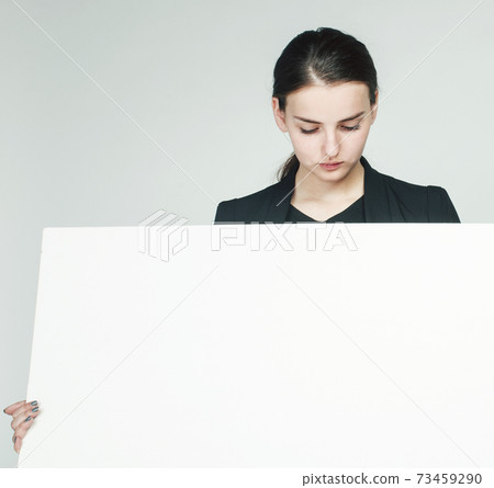 young pretty brunette girl with placard shit copyspace on white background wearing business costume student 73459290