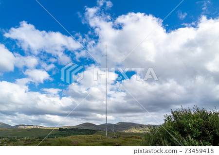 Street view of transmitter tower on an agricultural field in the irish highlands by Glenties in County Donegal 73459418