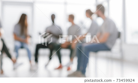 background image of a group of young people at a meeting in a conference room 73459924