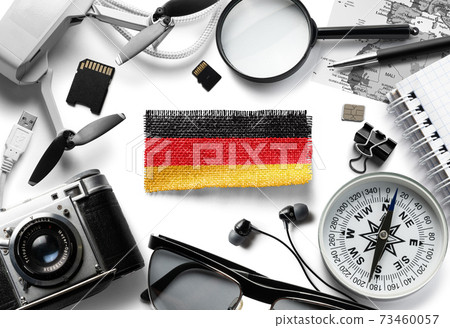 Flag of Germany and travel accessories on a white background. Flag of Germany and travel accessories on a white background. 73460057