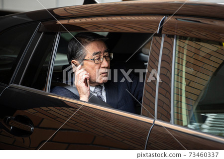 Male smartphone in a car Male smartphone in a car 73460337