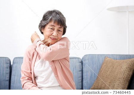 Senior woman stiff shoulders Senior woman stiff shoulders 73460445