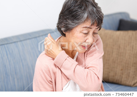 Senior woman stiff shoulders Senior woman stiff shoulders 73460447