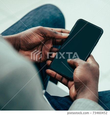 close up. business man using his smartphone 73460452