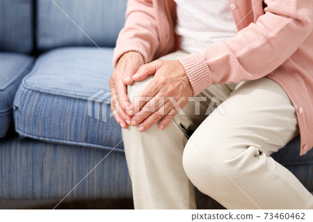 Senior women suffering from knee pain 73460462