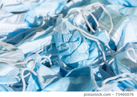 Texture of wrinkled protective face masks, discarded dirty trash. Texture of wrinkled protective face masks, discarded dirty trash. 73460876