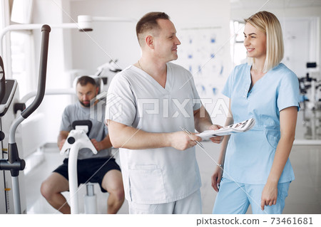 Doctor with a patient in physiotherapy clinic 73461681