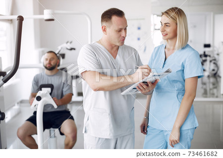 Doctor with a patient in physiotherapy clinic 73461682