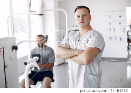 Doctor with a patient in physiotherapy clinic Doctor with a patient in physiotherapy clinic 73461683