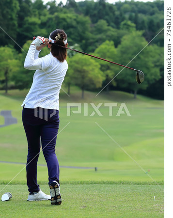 Woman hitting the tee shot 73461728