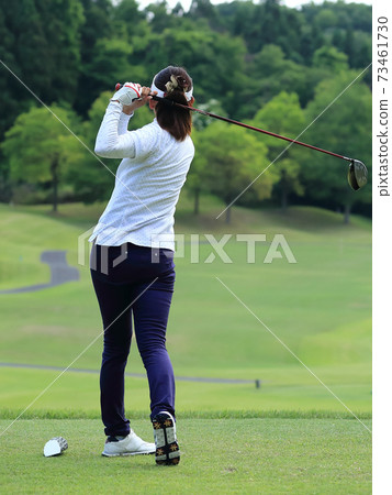 Woman hitting the tee shot 73461730