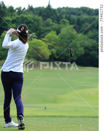 Woman hitting the tee shot 73461732
