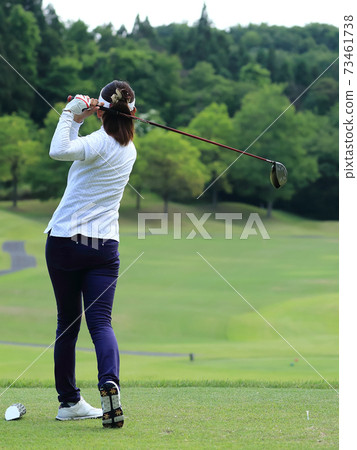 Woman hitting the tee shot Woman hitting the tee shot 73461738