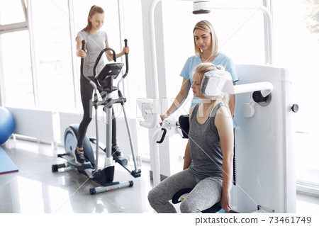 Woman having rehabilitation after injury in physiotherapy room Woman having rehabilitation after injury in physiotherapy room 73461749