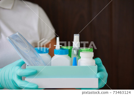 Medicine woman courier in mask and gloves with medical pills purchases Medicine woman courier in mask and gloves with medical pills purchases 73463124